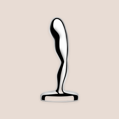 Anchoring — weighted intimate plug on a warm blush background