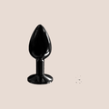 Bejewelled — weighted intimate plug on a warm blush background