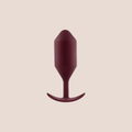 Borne — weighted intimate plug on a warm blush background