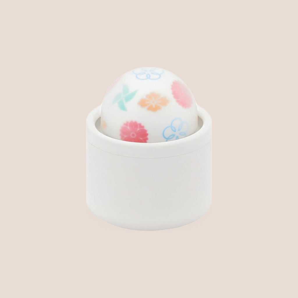 Breathe — intimate massager on a warm blush background