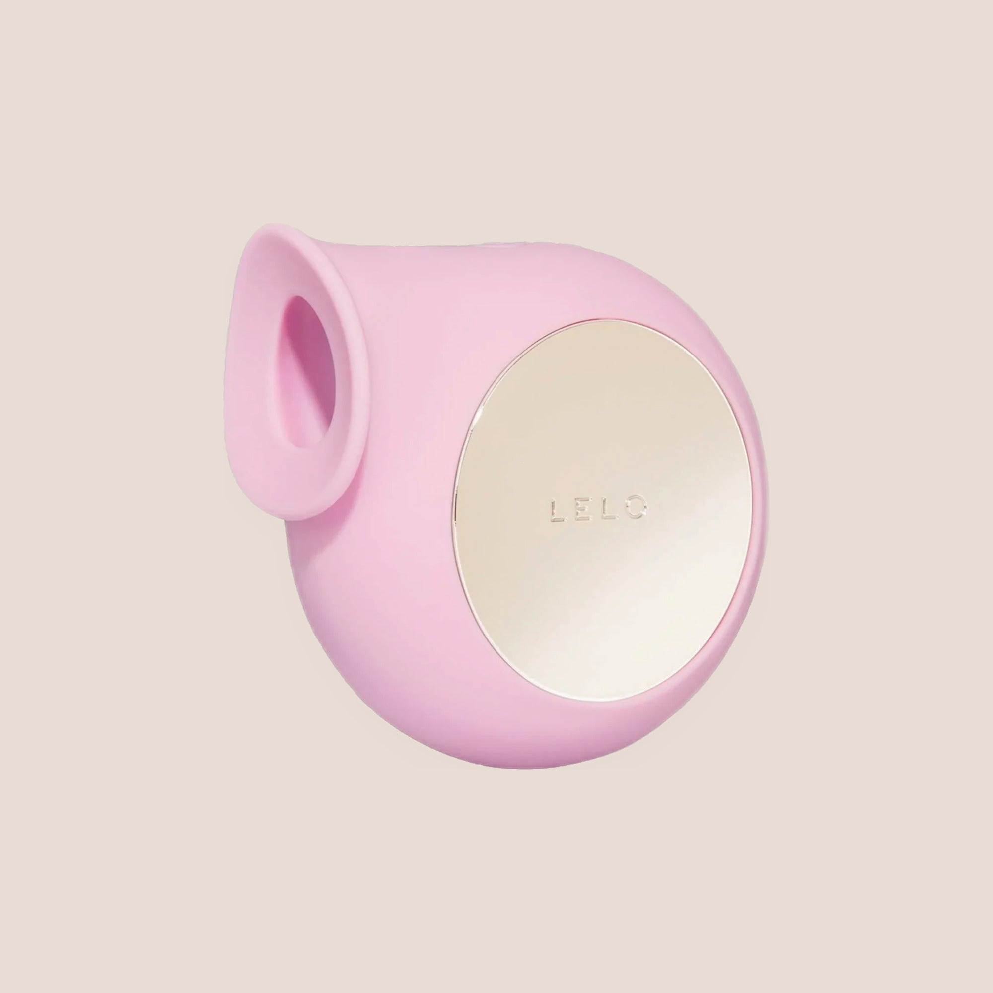 Caressed — intimate massager on a warm blush background