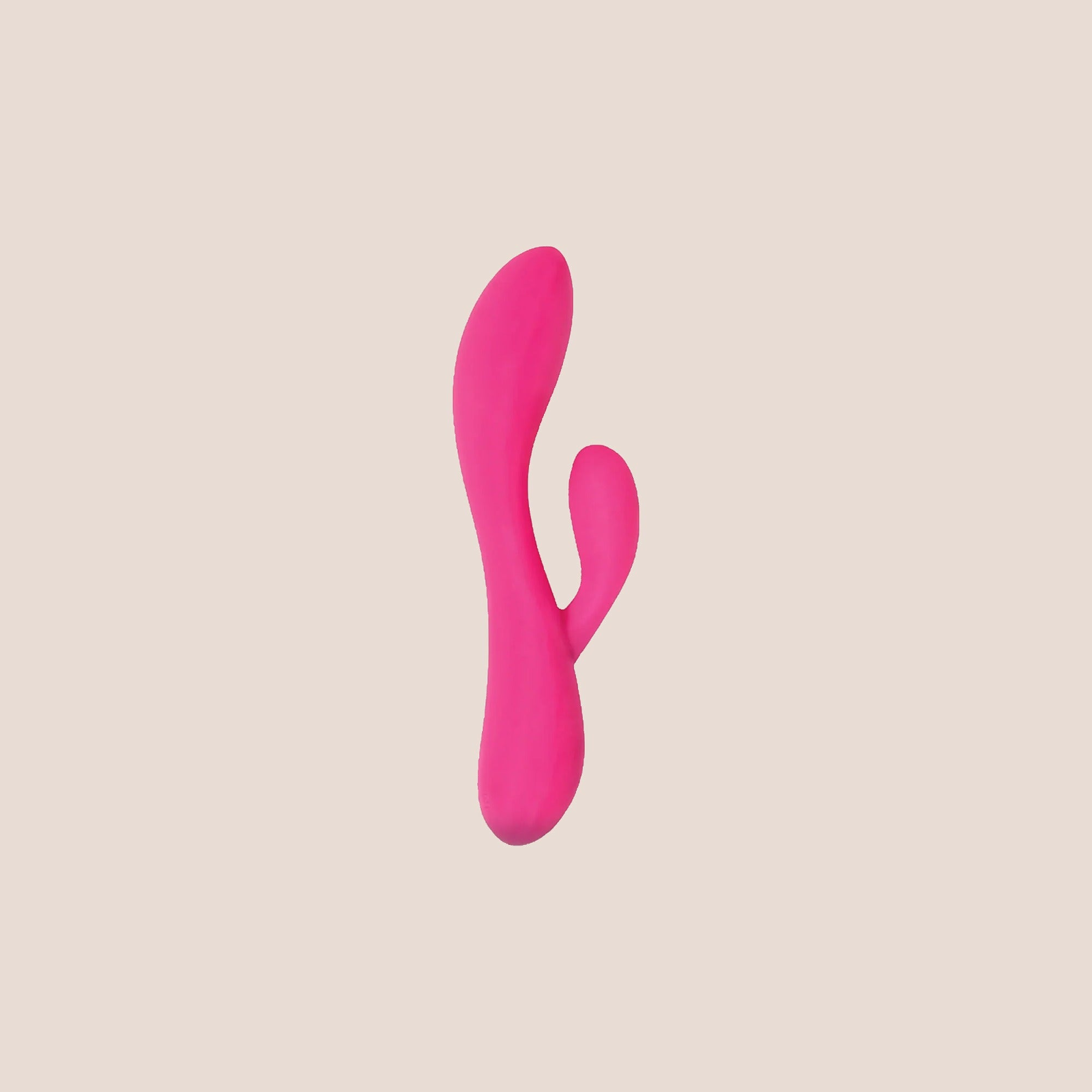 Dualized — intimate massager on a warm blush background