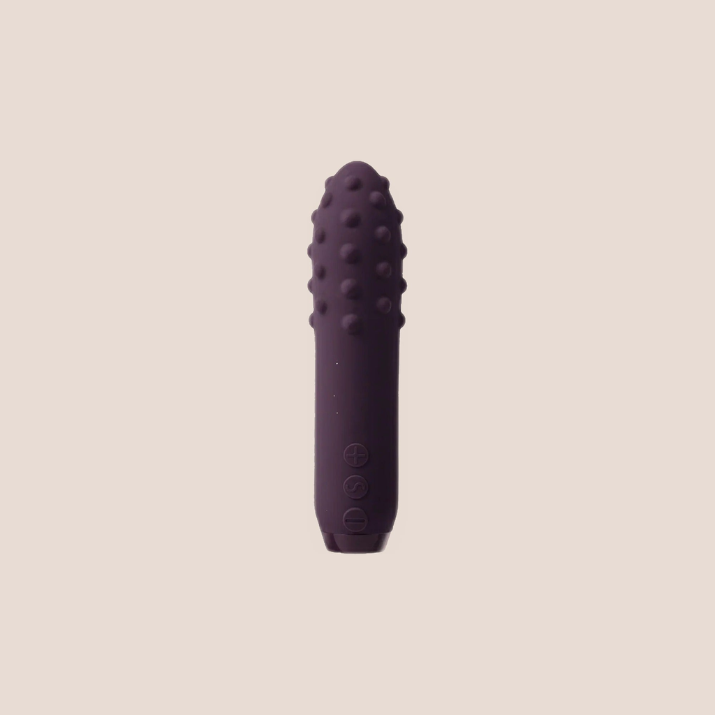 Scintillating — intimate massager on a warm blush background