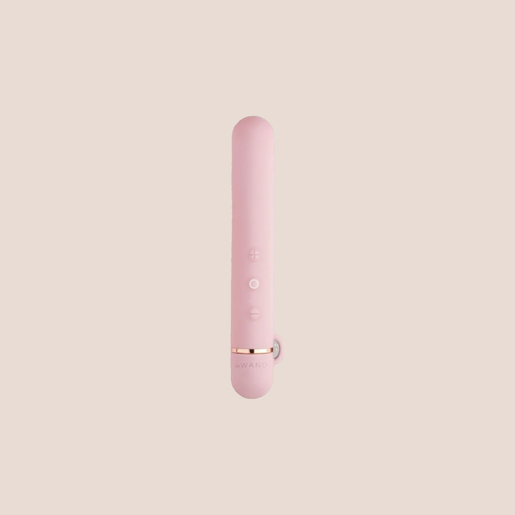 Forged — intimate massager on a warm blush background