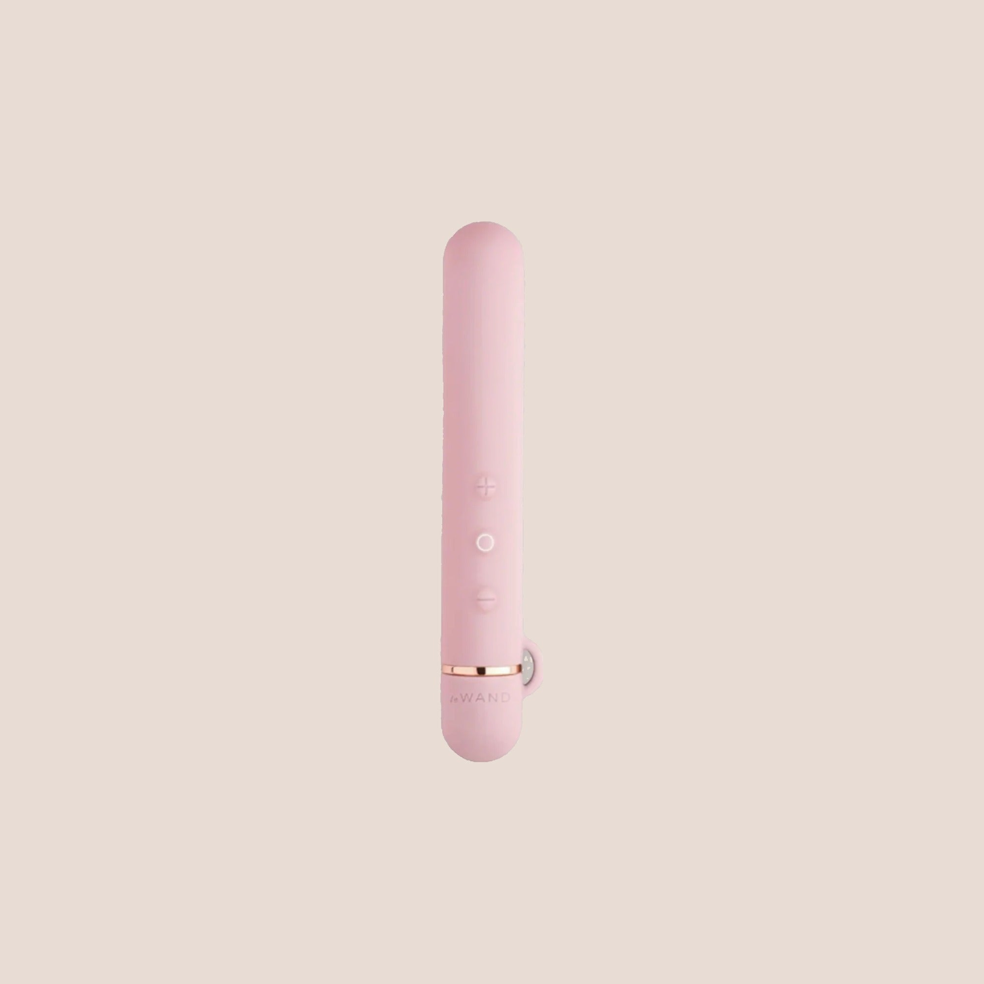 Forged — intimate massager on a warm blush background