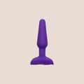 Girded — weighted intimate plug on a warm blush background