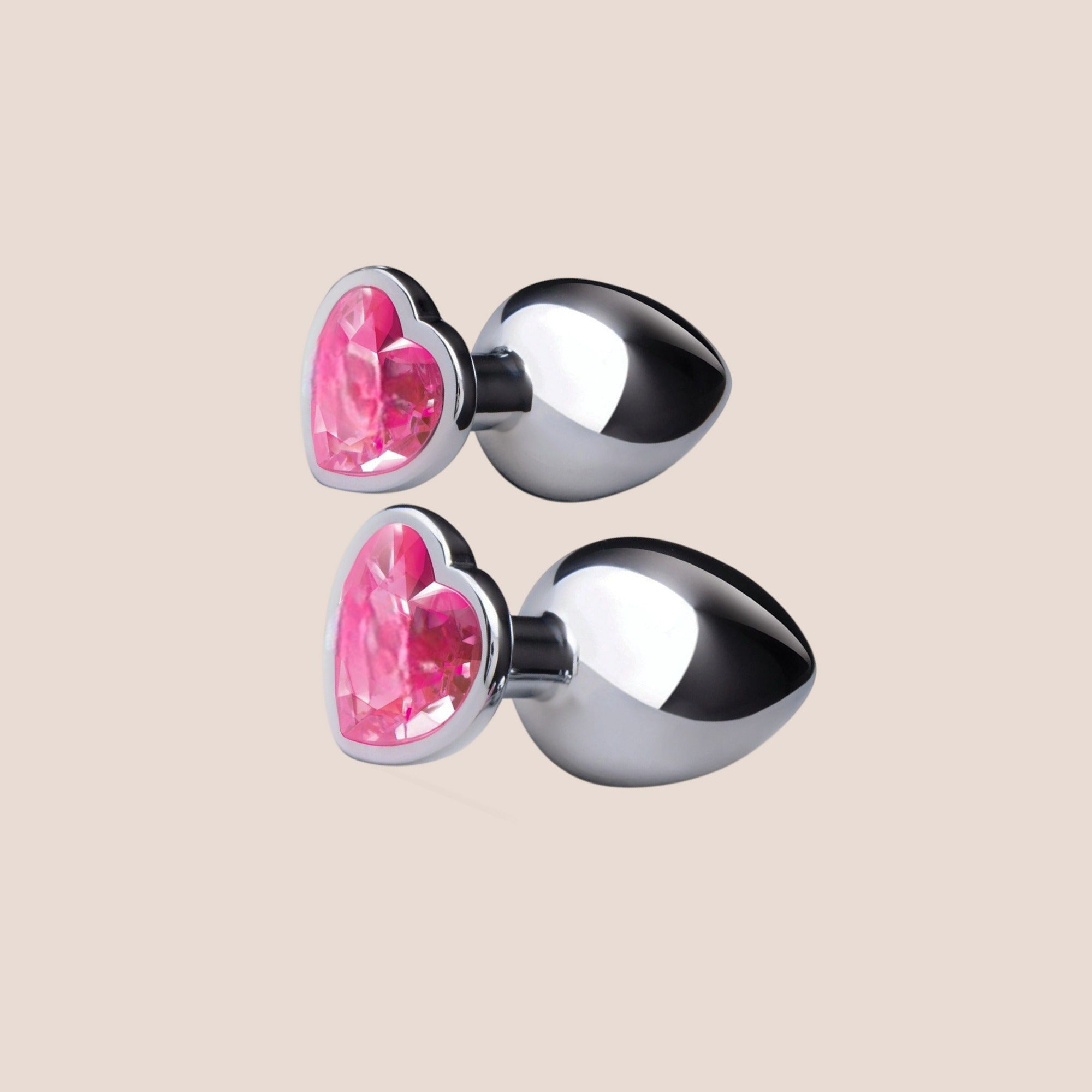 Illuminated — weighted intimate plug on a warm blush background