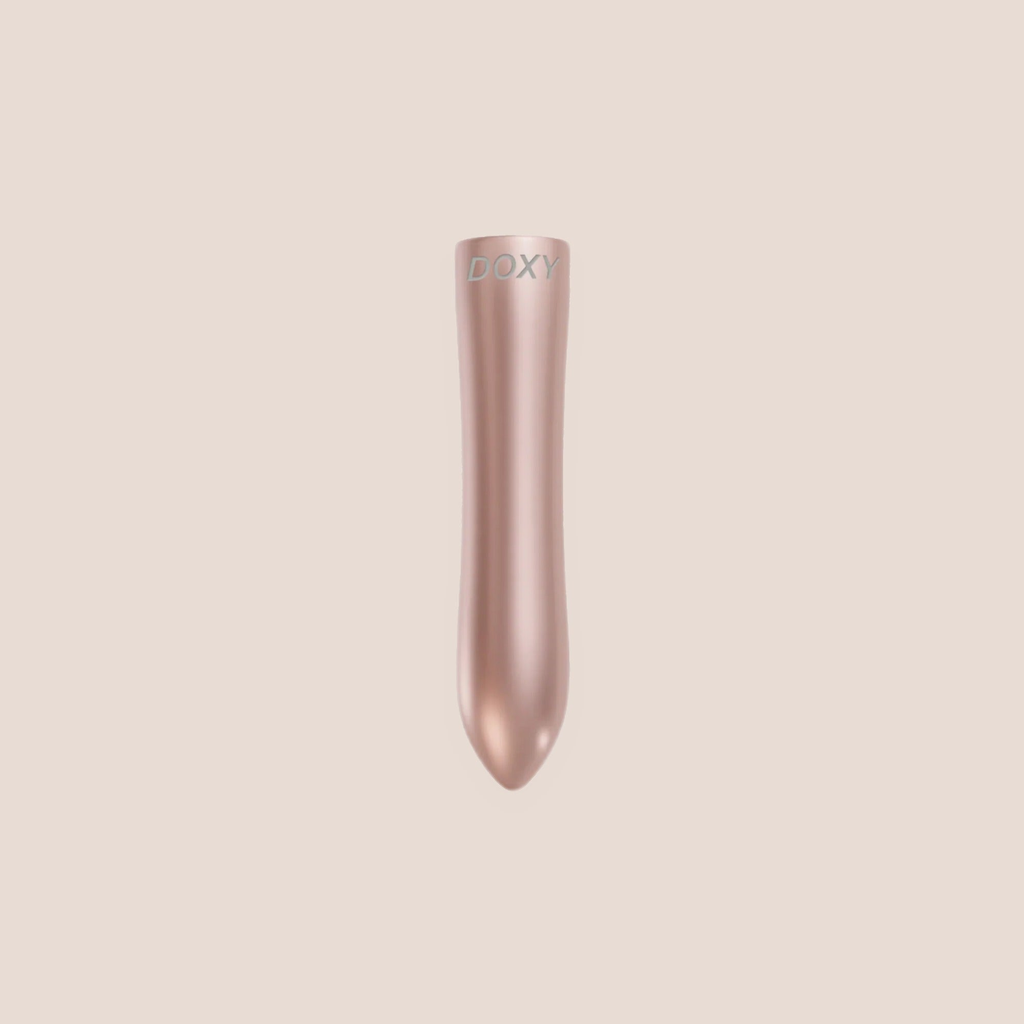 Whetted — intimate massager on a warm blush background
