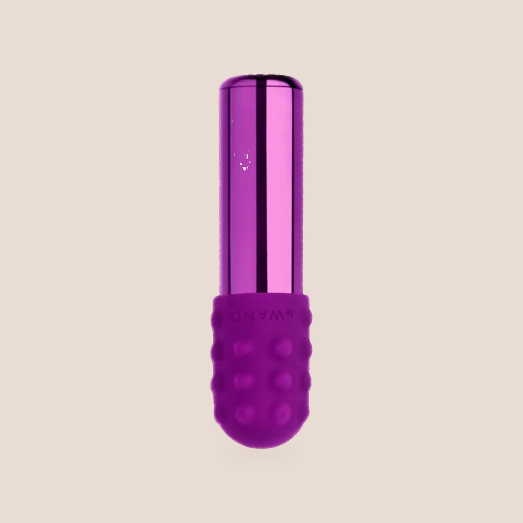 Moved — intimate massager on a warm blush background