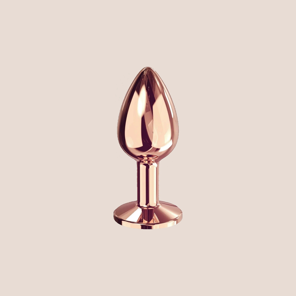 Radiant — weighted intimate plug on a warm blush background