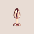 Radiant — weighted intimate plug on a warm blush background
