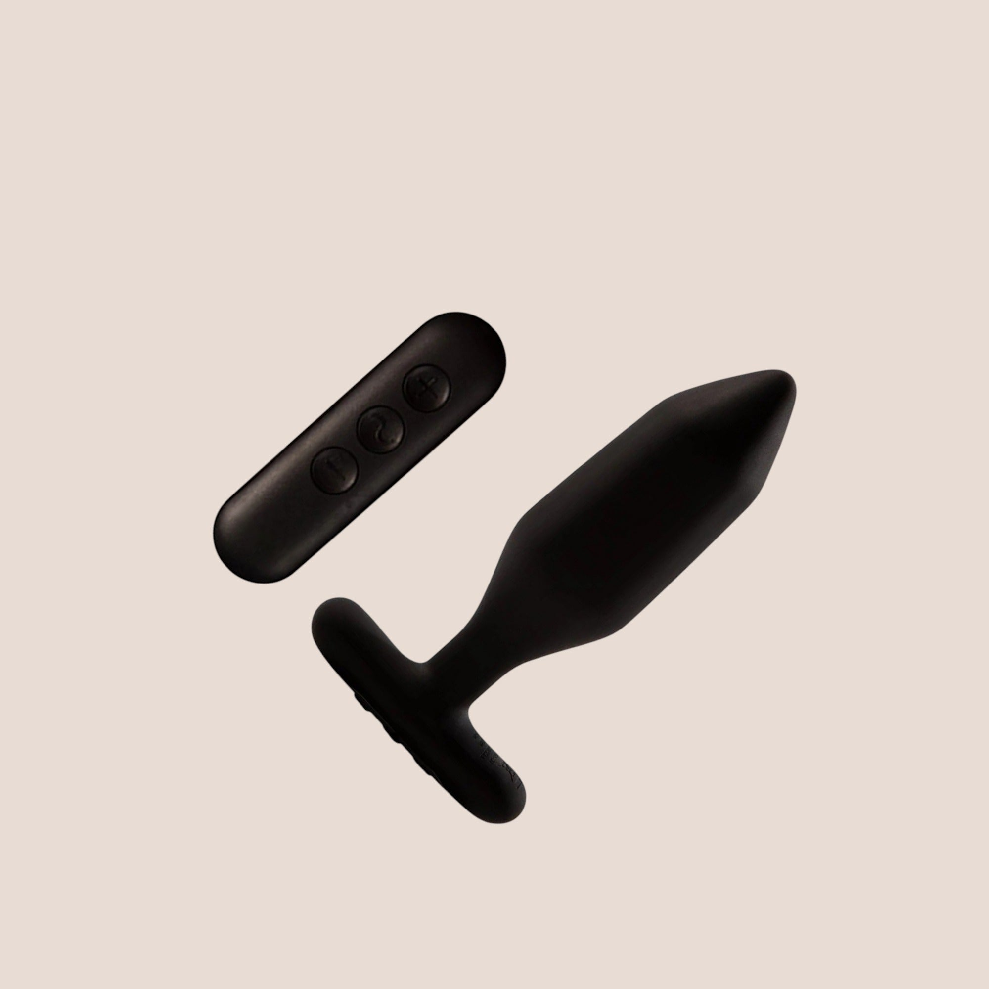 Resolute — weighted intimate plug on a warm blush background