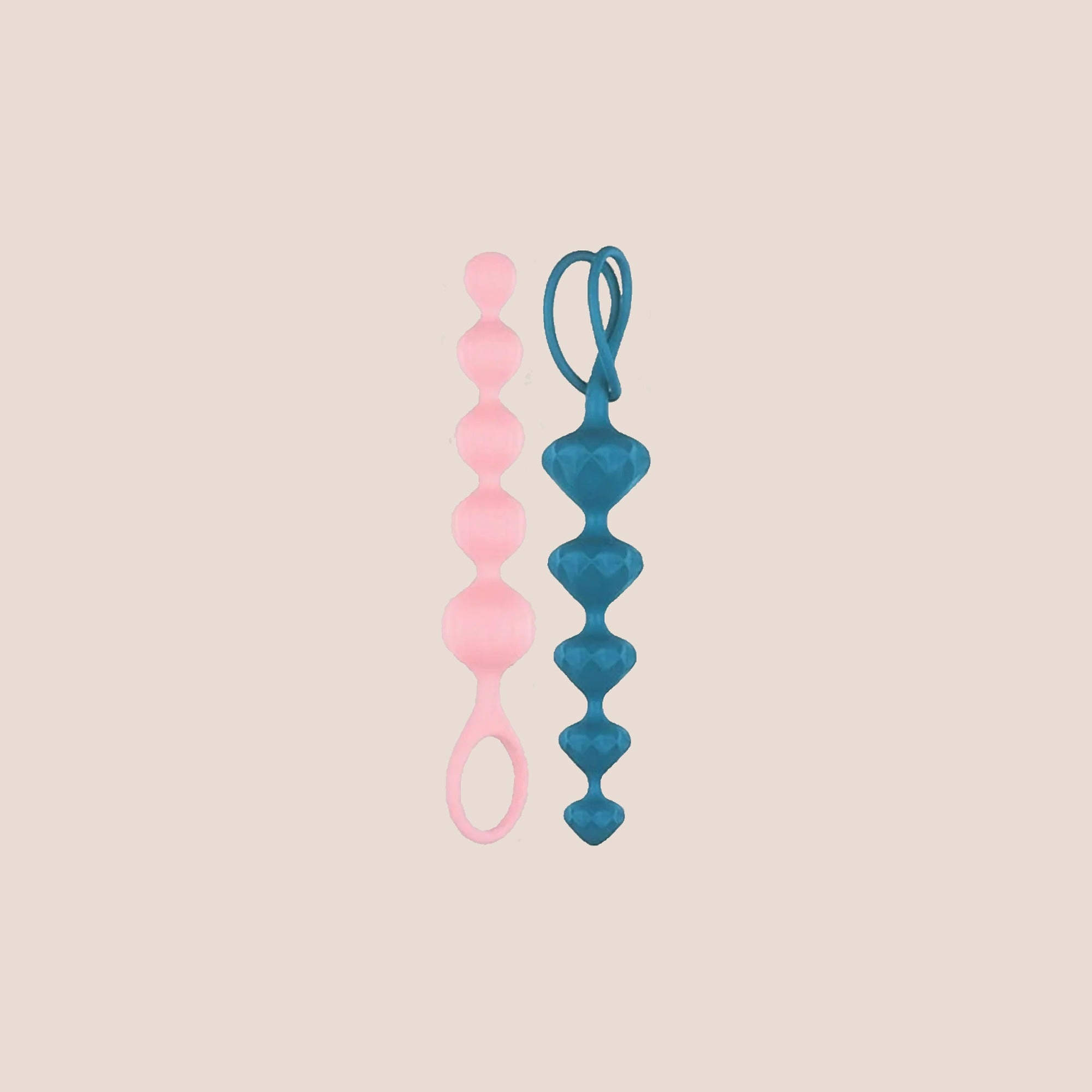 Seated — weighted intimate plug on a warm blush background