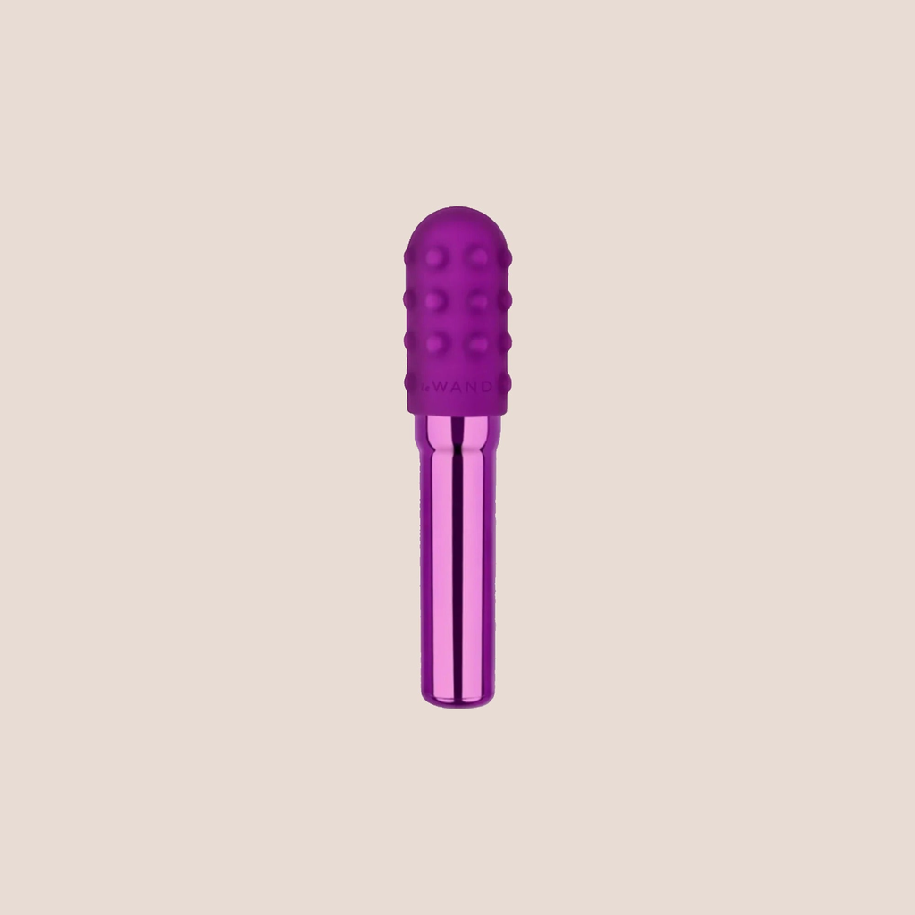 Sparked — intimate massager on a warm blush background