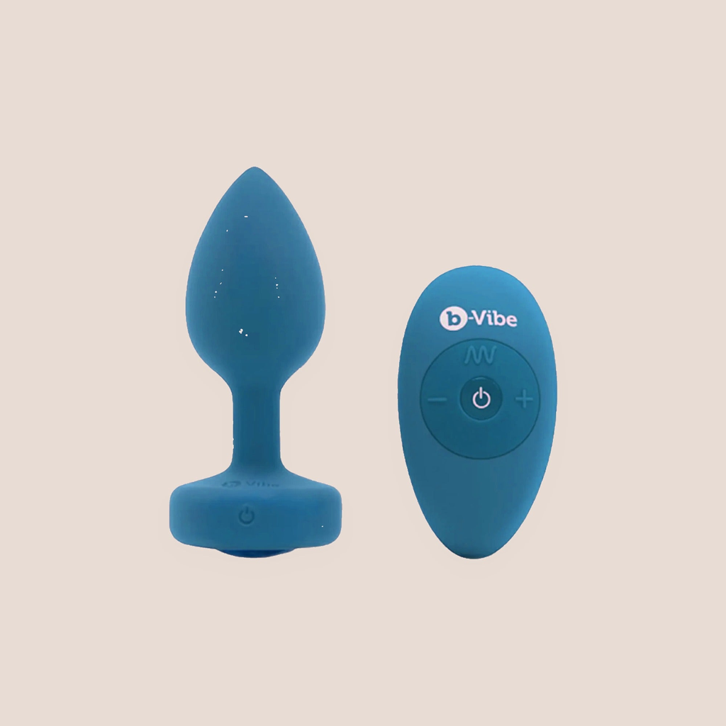 Swathed — weighted intimate plug on a warm blush background
