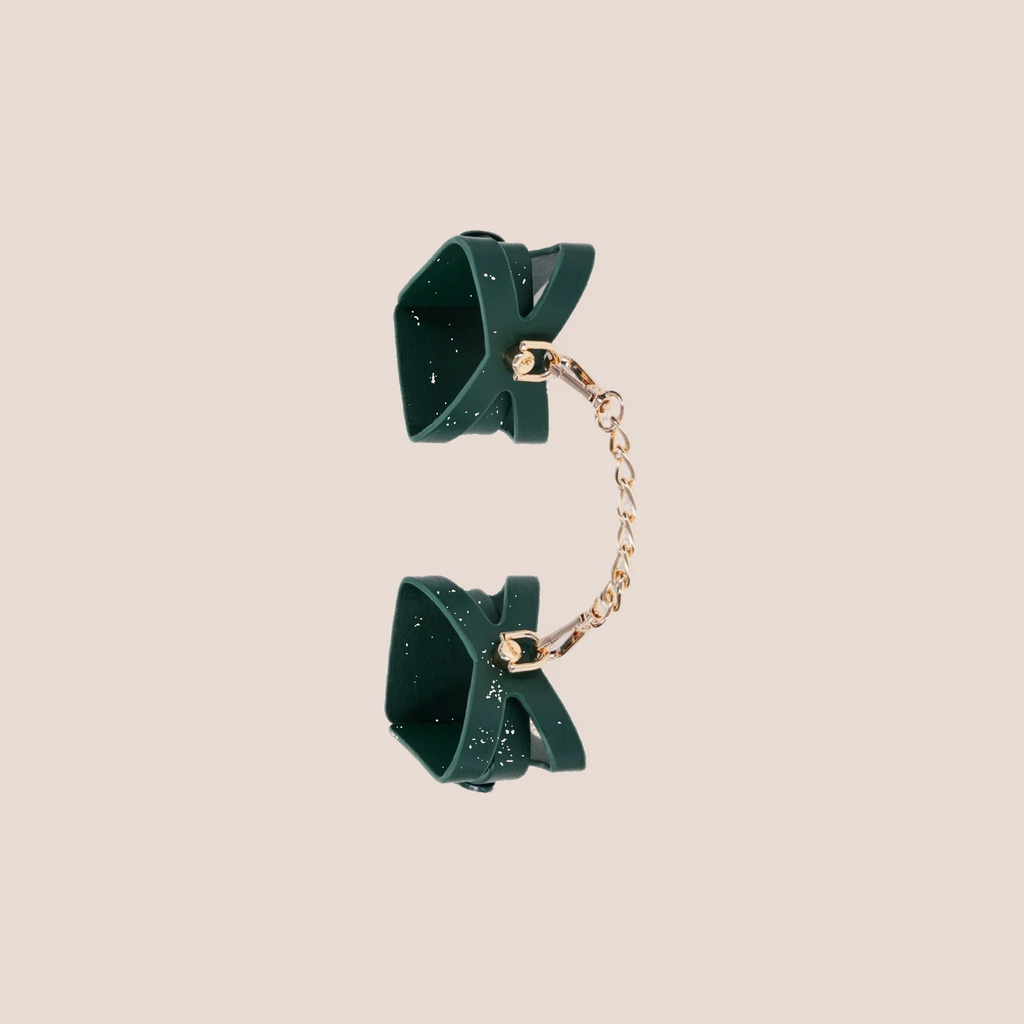Unveiled — restraint piece on a warm blush background