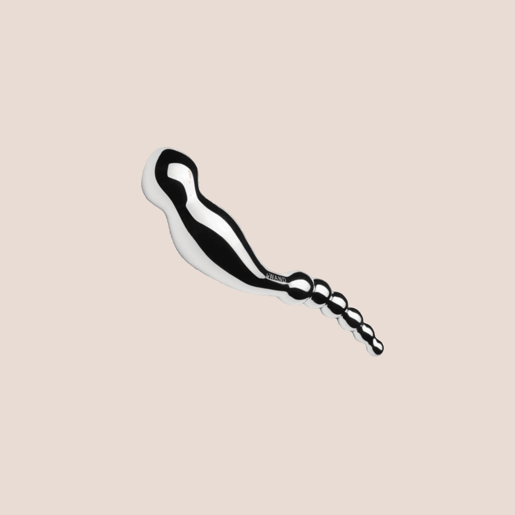 Wandering — weighted intimate plug on a warm blush background